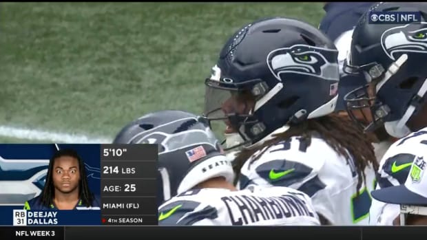 Seahawks running back DeeJay Dallas stands on sidelines.